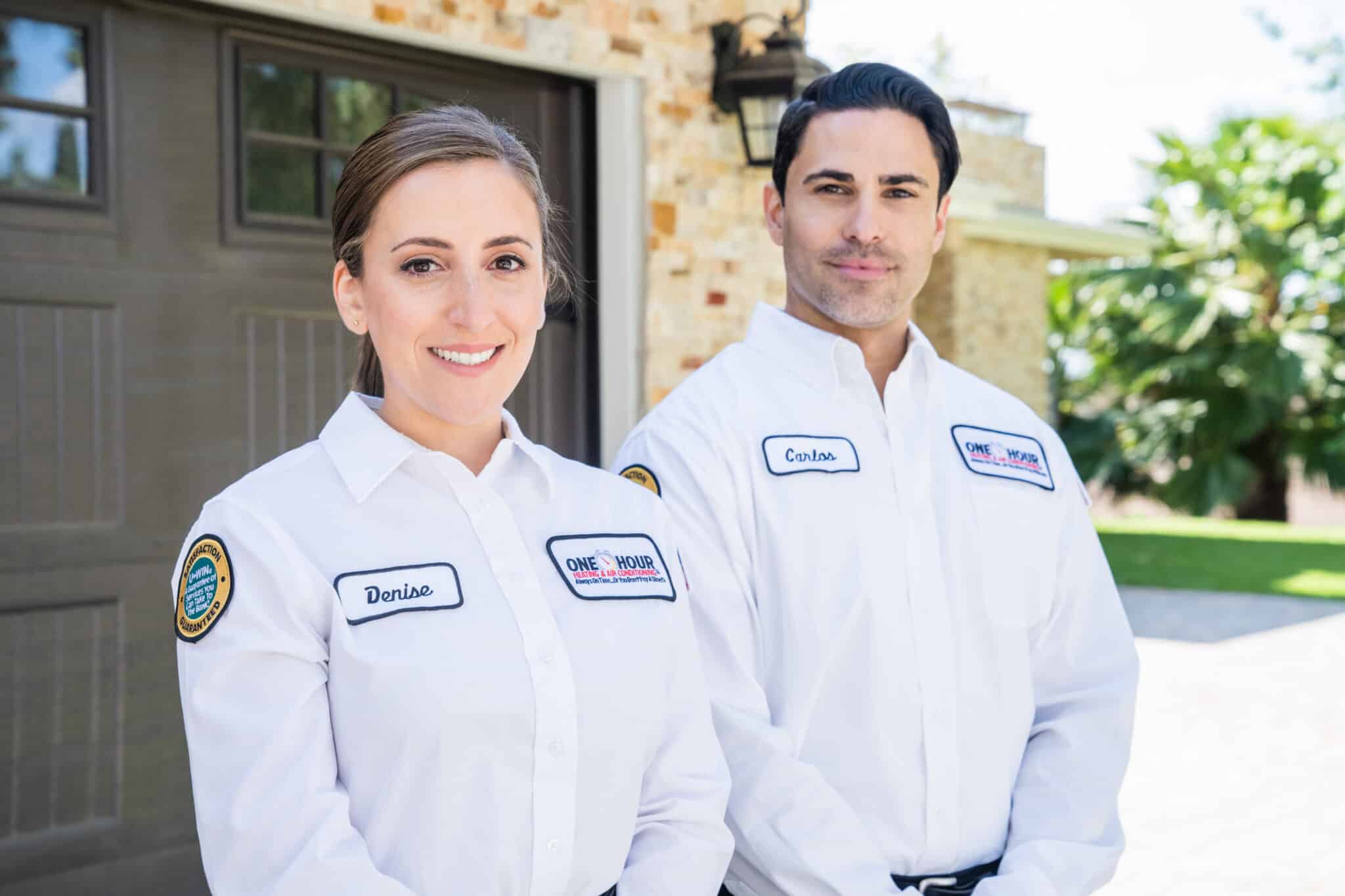Two One Hour Heating & AC technicians smiling in front of a Richmond Hill residence